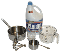 Bleach bottle, saucepan, measuring cup, and measuring spoons arranged on a white background.