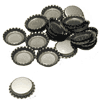 Pile of assorted metal bottle caps, some facing up and others down, scattered on a white surface.